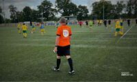Person with orange t-shirt on walking